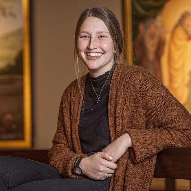 Smiling, female student in the chapel of one of the University of Mary residence halls. 